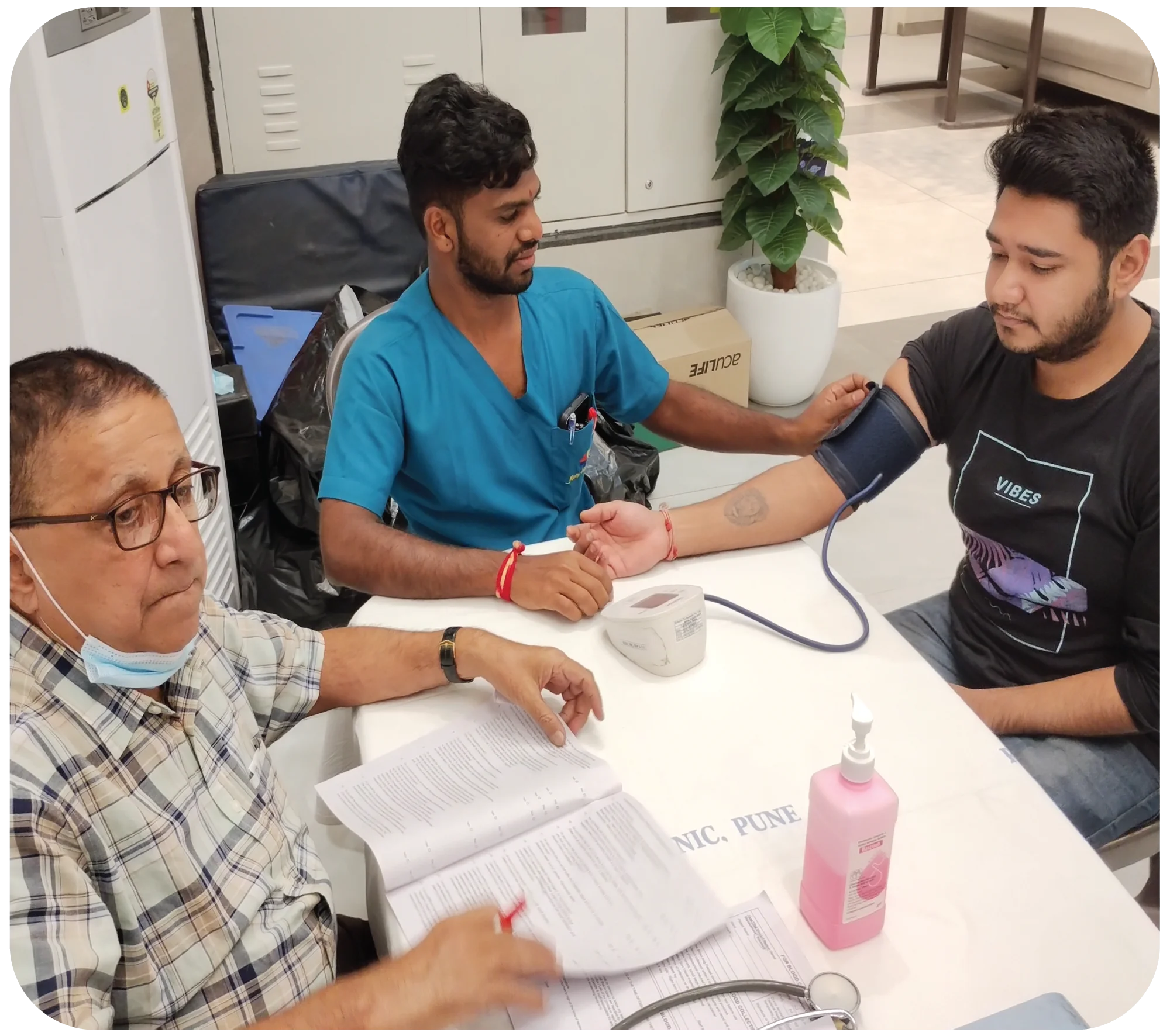 Doctor conducting pre-donation consultation and health check with donor